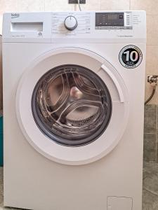 a white washing machine with its door open at Appartamento Roverella in Rovigo