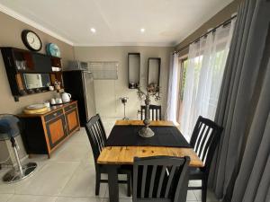 a dining room with a wooden table and chairs at ColtsRest in White River