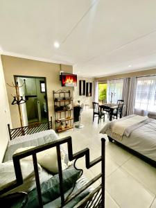 a bedroom with two beds and a dining room with a table at ColtsRest in White River