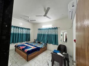 a bedroom with a bed and a table and chairs at Ranchhod Villa in Marwad
