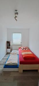 a bedroom with a bed and a window at Ferienwohnung Lene im Lauertal - Rhön in Maßbach