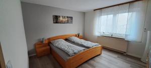 a small bedroom with a bed and a window at Ferienwohnung Lene im Lauertal - Rhön in Maßbach