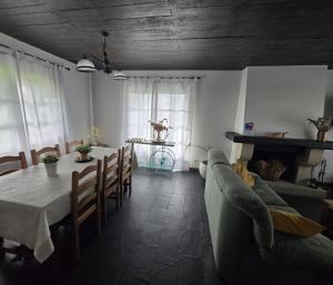 a living room with a table and a couch at Camiño da Vieira in Padrón
