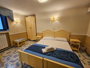 a bedroom with a bed with two towels on it at Le Ninfe Luxury Rooms in Naples