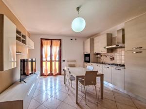 a kitchen with a table and chairs in a room at Appartamento Roverella in Rovigo