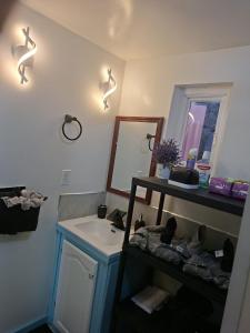 a bathroom with a sink and a mirror at Vacazure in Christ Church