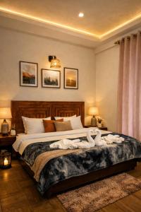 a bedroom with a large bed with towels on it at North star Manali in Vashisht