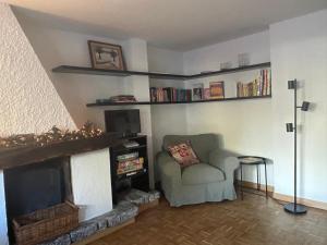 a living room with a chair and a fireplace at Tranquillità Vintage al Verrand con 3 camere in Verrand