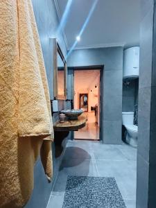 a bathroom with a sink and a toilet at Inass appartement in Essaouira +68 photos