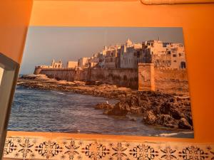 a picture of a city on a wall at Inass appartement in Essaouira