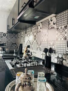 a kitchen with a stove and a counter top at Inass appartement in Essaouira