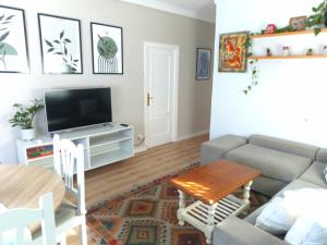 a living room with a couch and a table at Villasultana 1 in Chipiona