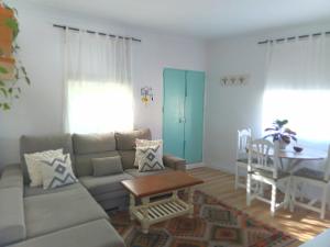 a living room with a couch and a table at Villasultana 1 in Chipiona