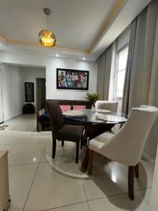 a living room with a dining room table and chairs at Apartamento Floripa in Florianópolis