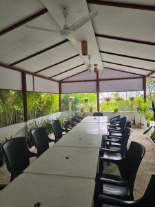 a large long table with chairs and a ceiling at IRIS Beach Residence in Guraidhoo +45 photos
