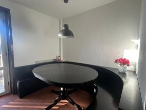 a black table in a room with a lamp at Tranquillità Vintage al Verrand con 3 camere in Verrand +10 photos