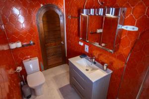 a bathroom with a toilet and a sink and a mirror at A pie de playa con Ascensor y Workspace By DelucaCo in Altea +35 photos