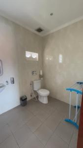 a bathroom with a toilet and a table in it at LA Homestay sanur in Sanur