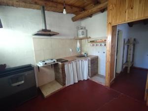 a kitchen with a stove and a counter top at Antonio House in Uspallata