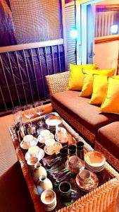 a living room with a coffee table with dishes on it at Grace House Hill Paradise Atami in Atami