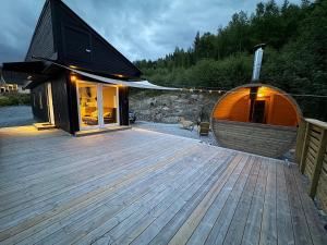 a large wooden deck in front of a building at The Container House in Fyresdal