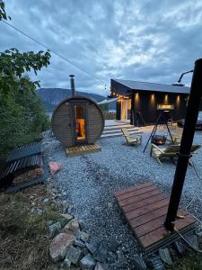 a round building with a door on a gravel yard at The Container House in Fyresdal
