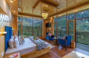 a bedroom with a bed in a room with windows at The 14 Gables, A Boutique Stay, Manali - Pet Friendly - Balcony Rooms - Crown Palace in Manāli
