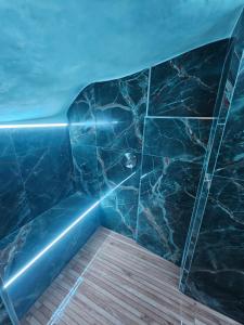 a bathroom with a black marble shower with a wooden floor at Florence Colonna Spa in Florence