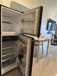 a refrigerator with its door open in a kitchen at Ormoc Gdex Transient in Ormoc