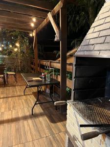 a patio with a table on a wooden deck at Refúgio Bosques de Itu in Itu