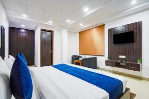 a bedroom with a large bed and a television at Yashobhoomi Grand in Jāmb