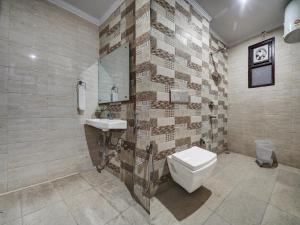 a bathroom with a toilet and a sink at Yashobhoomi Grand in Jāmb