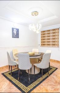 a dining room with a table and chairs at 4 Kays Apartment in Agege