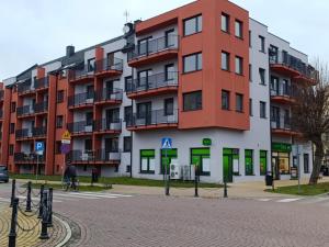 a large apartment building on the side of a street at Apartament Kaszmir 3 in Sławno