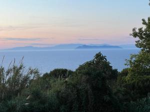 a view of the ocean with mountains in the distance at La Cupoletta Ponza in Arcipelago Ponziano +2 photos