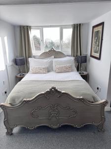 a bedroom with a large bed with a large window at Abbey view in Selby