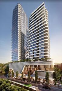 two tall buildings in a city with a street at Spacious 4BR penthouse in Box Hill Free Parking x 2 in Box Hill