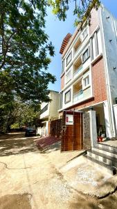 a building with a gate in front of it at Q by Kolam - Women and Family Serviced Apartments, Thoraipakkam, OMR in Chennai