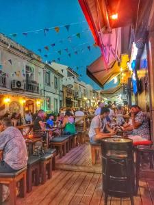 a group of people sitting at tables in a restaurant at Sunny Haven Alvor in Alvor