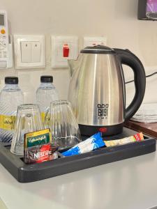 a tray with a tea kettle on top of a counter at شقق أريز ستاي in Al Hada +12 photos