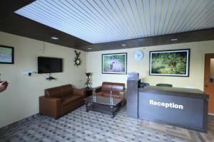 a waiting room with a reception desk and a couch and a television at Jungle View Resort Ranthambhore in Khilchipur
