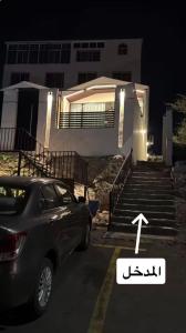 a car parked in a parking lot in front of a house at شقق أريز ستاي in Al Hada