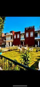 a view of a building with a park with benches at RamaLand A complete Stay in Faizābād