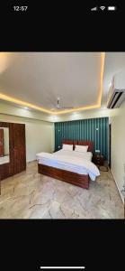 a large bedroom with a large bed in it at RamaLand A complete Stay in Faizābād