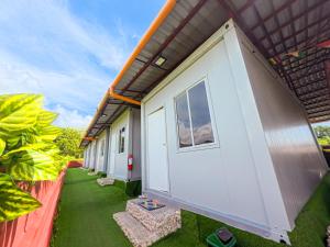 a row of cottages on a lawn next to a building at Banana Bar San Juan Family Digital Nomad Stay Starlink Fast WiFi Solar Backup in San Juan