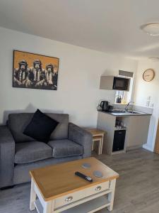 a living room with a couch and a table at Inverness Ardtower Escapes in Culloden