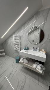 a bathroom with a white sink and a mirror at Il Vicoletto room in Mercato San Severino +53 photos