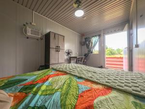 a bedroom with a large bed with a colorful comforter at Banana Bar San Juan Family Digital Nomad Stay Starlink Fast WiFi Solar Backup in San Juan