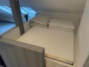 a bed in a room with a window at Loft mit Kaminofen - Karlsdorf in Karlsdorf-Neuthard