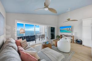 a living room with a couch and a view of the ocean at Captiva Hide A Way 2D in Captiva